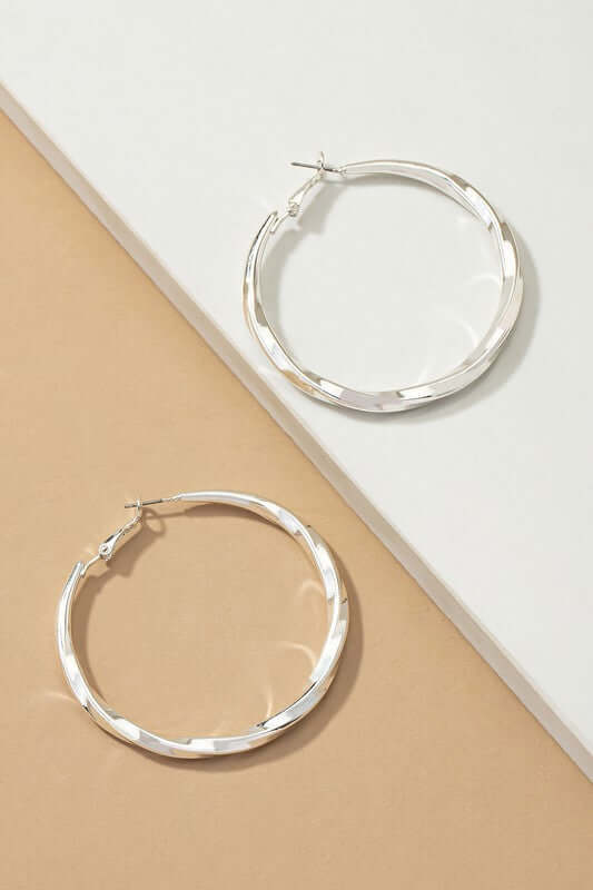 Twisted tube hoop earrings in silver featuring a modern design, 2-inch diameter, perfect for any occasion.