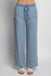 Light blue elastic waist Tencel pants with relaxed fit, styled with white sandals, perfect for casual or office wear.