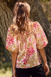 Fuchsia floral and amber striped blouse with puff sleeves and ribbon tie, perfect for a bold, feminine style.