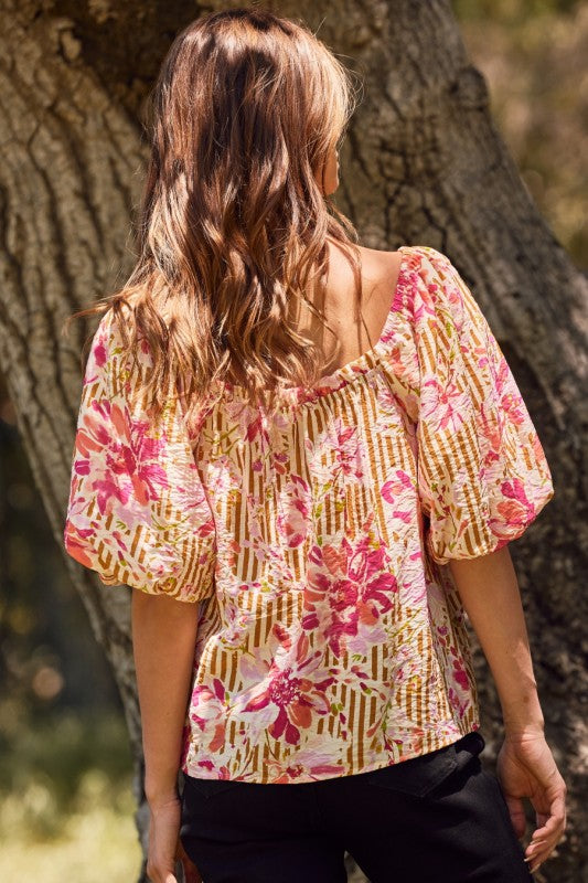 Fuchsia floral and amber striped blouse with puff sleeves and ribbon tie, perfect for a bold, feminine style.