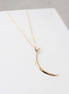 Gold crescent moon necklace on an 18" chain, perfect for layering or gifting to moon and star lovers.