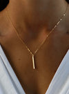 Gold Petite Bar Necklace worn on model, showcasing its simple and chic design for everyday elegance.