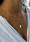 Gold Petite Bar Necklace worn on model, showcasing its simple and chic design for everyday elegance.