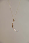 Gold crescent moon necklace on an 18" chain, perfect for layering or gifting to moon and star lovers.