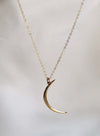 Gold crescent moon necklace on an 18" chain, perfect for layering or gifting to moon and star lovers.