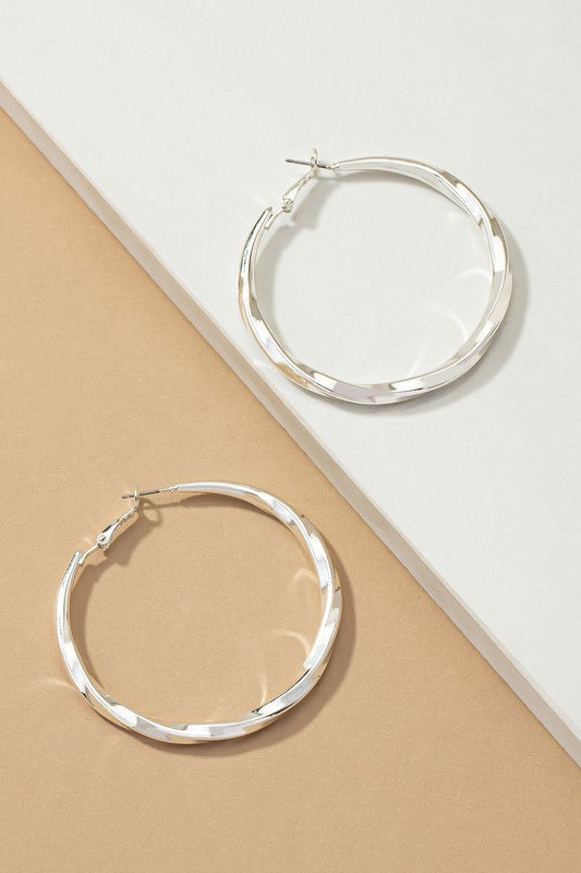 Twisted tube hoop earrings in silver featuring a modern design, 2-inch diameter, perfect for any occasion.