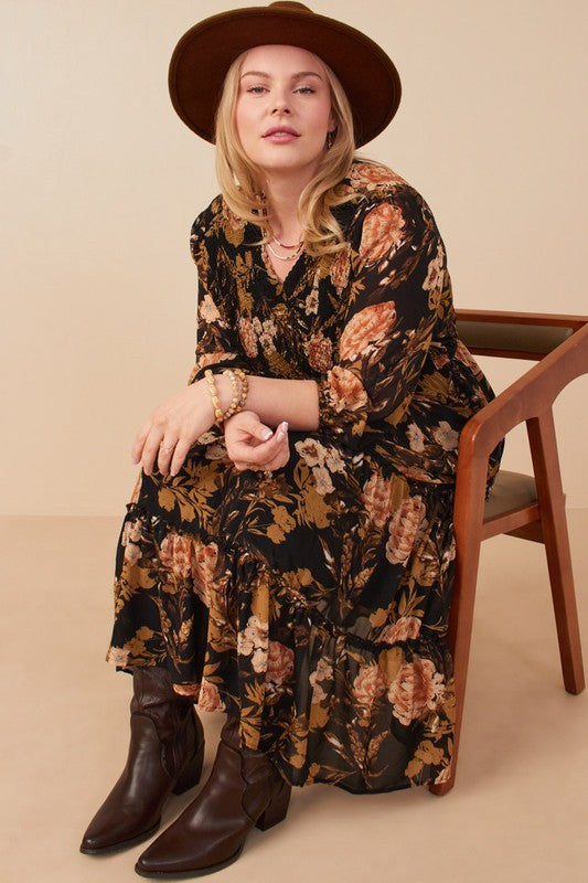 Curvy model wearing Hannah Romantic Floral Smocked Dress in Black, featuring floral print and three-quarter sleeves.
