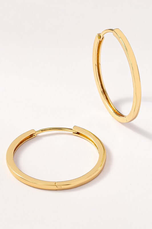 Classic hinged hoop earrings in polished gold with a sleek design, perfect for any outfit and versatile wear.