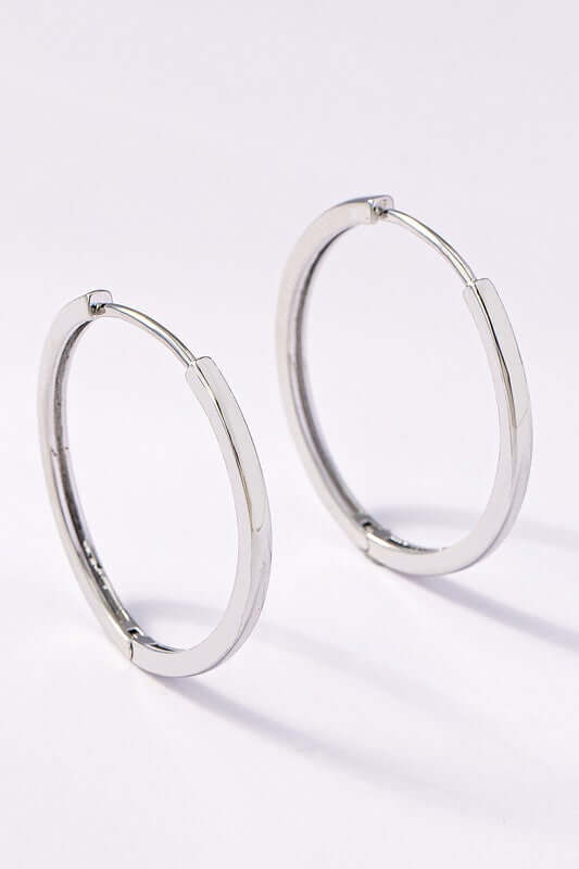 Classic polished silver hinged hoop earrings with invisible post clasp for secure wear.
