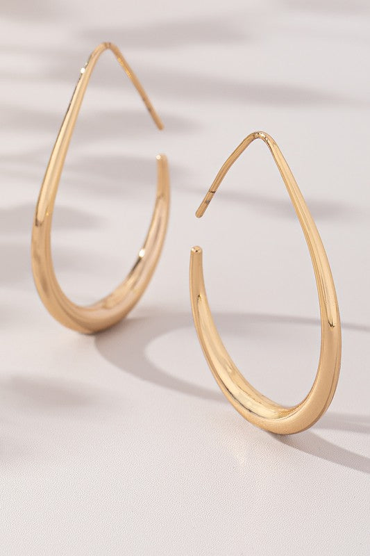 Sleek teardrop hoop earrings in polished gold with an elongated design, perfect modern statement pieces.