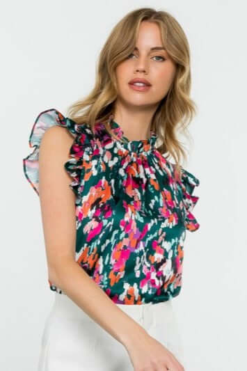 Close up of Eva Abstract Print Ruffle Trim Blouse in Teal with vibrant colors and ruffle cap sleeves, perfect for casual or dressy outfits.